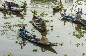 Africa, Benin, Lake Nokoua. Boat traffic in the famous stilt village of Ganvie