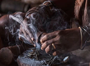 Africa, Namibia, Damara Land. Preparing traditional Himba perfume