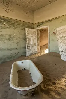 Africa, Namibia, Kolmanskop. Bathtub inside one of the abandoned buildings