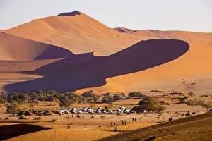 Images Dated 12th October 2017: Africa, Namibia, Namib Desert, Sossusvlei, dunes at sunrise with 4x4 offroad cars