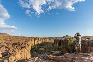 Damaraland Gallery: Africa, Namibia, Palmwag. Ranger looking over the Aub Canyon