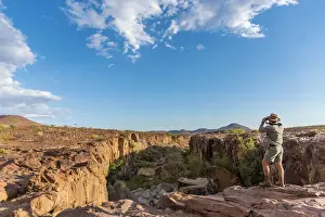 Palmwag Prints: Africa, Namibia, Palmwag. Ranger looking over the Aub Canyon