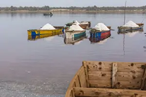 Senegal Prints: Africa, Senegal, Pink Lake. Salt collecting boats on shore of the lake