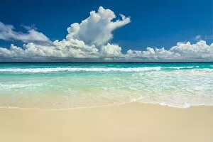 Africa, Seychelles, La Digue. Beach, sand, waves, clouds at Grand Anse