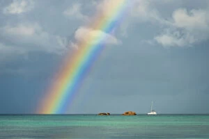 Africa, Seychelles, Praslin. A rainbow over the ocean seen from Anse Volbert