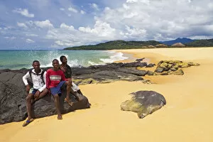 Images Dated 6th March 2012: Africa, Sierra Leone, Freetown Peninsula, John Obey Beach. Boys sitting on rocks