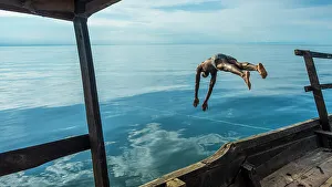 Africa, Tanzania, Mahale Mountains National Park. Jumping for a swim in the Tanganyika lake