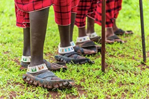 Images Dated 19th December 2022: Africa, Tanzania, Manyara Region. Maasai men's feet with their typical shoes made of motorcycle tyre