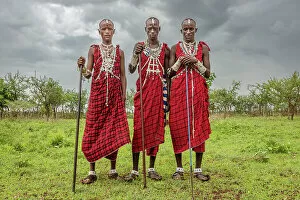 Images Dated 19th December 2022: Africa, Tanzania, Manyara Region. Young warriors posing for with traditional jewellery and dresses