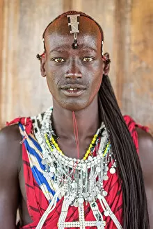 Images Dated 19th December 2022: Africa, Tanzania, Manyara Region. Young warrior posing for a portrait with traditional jewellery