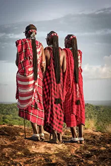 Images Dated 19th December 2022: Africa, Tanzania, Manyara Region. Maasai warriors on a rock showing their traditional braids
