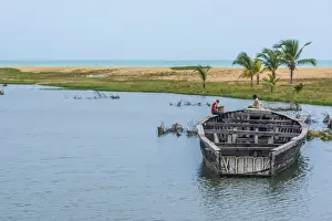Africa, Togo, Aneho. Old wooden fishing boat in the harbour of Aneho, a colonial town