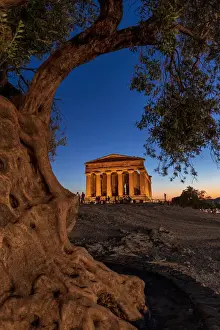 Agrigento, Sicily. People visiting Concordia Temple in the Valley of Temples at dusk