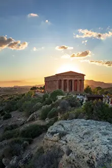 Agrigento, Sicily. Tourists visiting Concordia Temple in the Valley of Temples at sunset