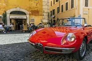 Alfa Romeo Duetto spider parked in a cobblestone street of Rome, Lazio, Italy