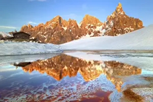 An alpin lake in springtime its reflecting the Segantini Hut and the famous Pale
