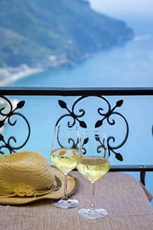 Images Dated 22nd July 2015: Amalfi Coast, Italy, a table for two, a summer hat and two glasses of white wine with