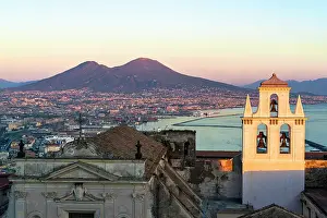 Baroque Style Prints: Ancient church and Gulf of Naples with Vesuvius seen from Sant'Elmo castle at sunset