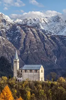 Ancient church of Valle di Cadore and snowcapped Dolomiti di Oltrepiave on