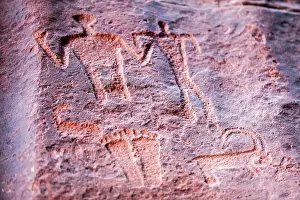 Jordanian Prints: Ancient prehistoric petroglyphs on a rock of the Wadi Rum desert
