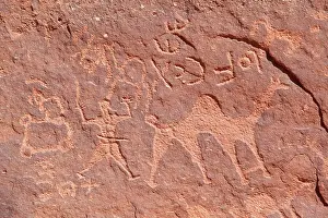 Jordanian Prints: Ancient prehistoric petroglyphs on a rock of the Wadi Rum desert