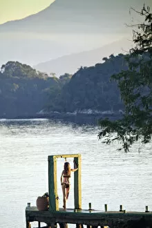 Images Dated 4th December 2012: Angra dos Reis; Green Coast (Costa Verde) Ilha Grande, a model stands in an arch