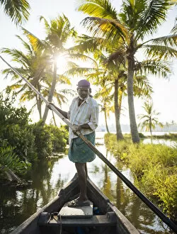 Images Dated 29th March 2021: Anthony the boatman guiding the vessel through Keralan backwaters near North Paravoor