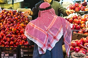 Amman Prints: Arab man waerinf Keffiyeh buying apples in market, Amman, Jordan