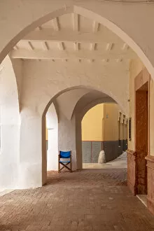 An arched colonnade in the old town of Ciutadella, Ciudadela, Menorca, Minorca