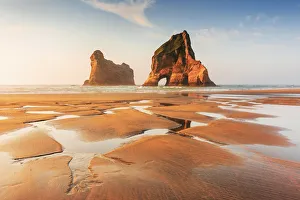 Archway sea stacks in the Tasman sea at Wharariki beach, Nelson, South Island