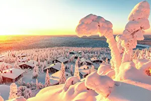 Rooftop Prints: Arctic sunrise over ice sculptures and snowy mountain huts from Huippupolku nature trail on Iso Syote peak