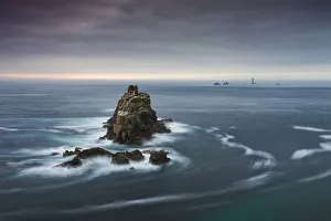 The Armed Knight rock stack and Longships Lighthouse off the coast at Land's End The Armed Knight rock stack and Longships Lighthouse off the coast at Land's End
