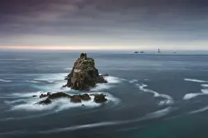 The Armed Knight rock stack and Longships Lighthouse off the coast at Lands End