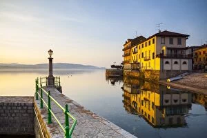 Lago Maggiore Gallery: Aronas Picturesque lake-front illuminated at sunrise, Arona, Lake Maggiore, Piedmont