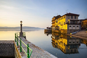 Aronas Picturesque lake-front illuminated at sunrise, Arona, Lake Maggiore, Piedmont