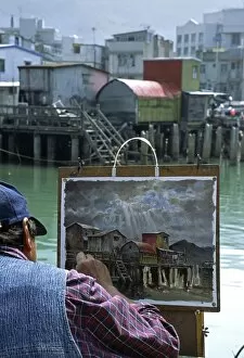 Water Way Gallery: An artist at work painting the stilt house village