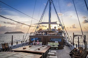 Maluku Prints: Asia, Indonesia, Spice Islands, Maluku, tourists relaxing on the the deck of the Seatrek