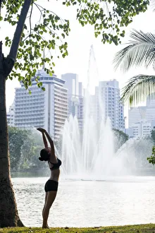 Fountains Prints: Asia, South East Asia, Thailand, Bangkok, Lumphini Park, a Caucasian woman practising
