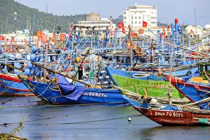 Asia, South East Asia, Vietnam, Danang, wooden fishing boats in harbour flying Vietnamese