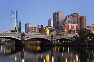 Australia, Victoria, Melbourne. Princes Bridge on the Yarra River, with the city skyline at dusk