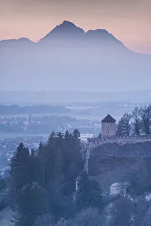 Austria, Salzburgerland, Salzburg, Richterhohe fortress and mountains, winter. dusk