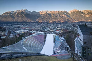 Austria, Tyrol, Innsbruck, ski jump and city view at sunset from the Bergeisel, Olympic