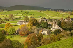 Autumn colours surround the picturesque Yorkshire Dales village of Burnsall, Wharfedale