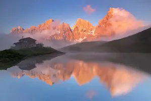 Pass Prints: Baita Segantini refuge and Pale di San Martino at sunset in Dolomites