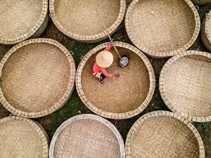 Phu Yen Province Prints: Bamboo basket fishing boats known as Thung Chai being waterproofed at An Dan village
