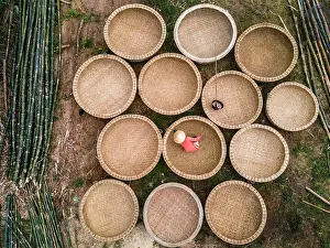 Vietnamese Prints: Bamboo basket fishing boats known as Thung Chai being waterproofed at An Dan village