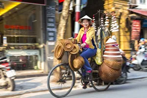Basket & hat seller on bicycle, Hanoi, Vietnam