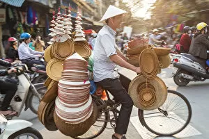 Seller Gallery: Basket & hat seller on bicycle, Hanoi, Vietnam
