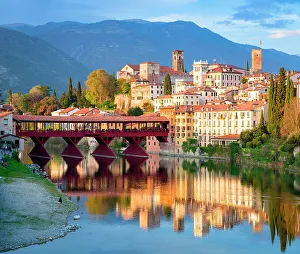 Beauty Prints: Bassano Del Grappa mirrored in river Brenta at sunset, Vicenza province, Veneto, Italy