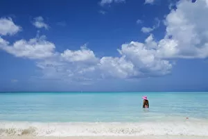 Images Dated 9th September 2016: A bather with a pink hat in the turquoise waters of the Caribbean Sea The Nest Antigua